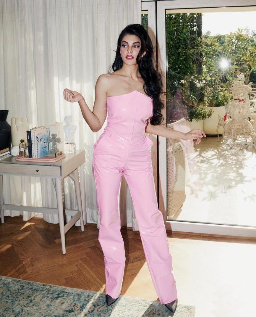 Jacqueline stuns in a strapless jumpsuit, exuding charm and glamour with every step